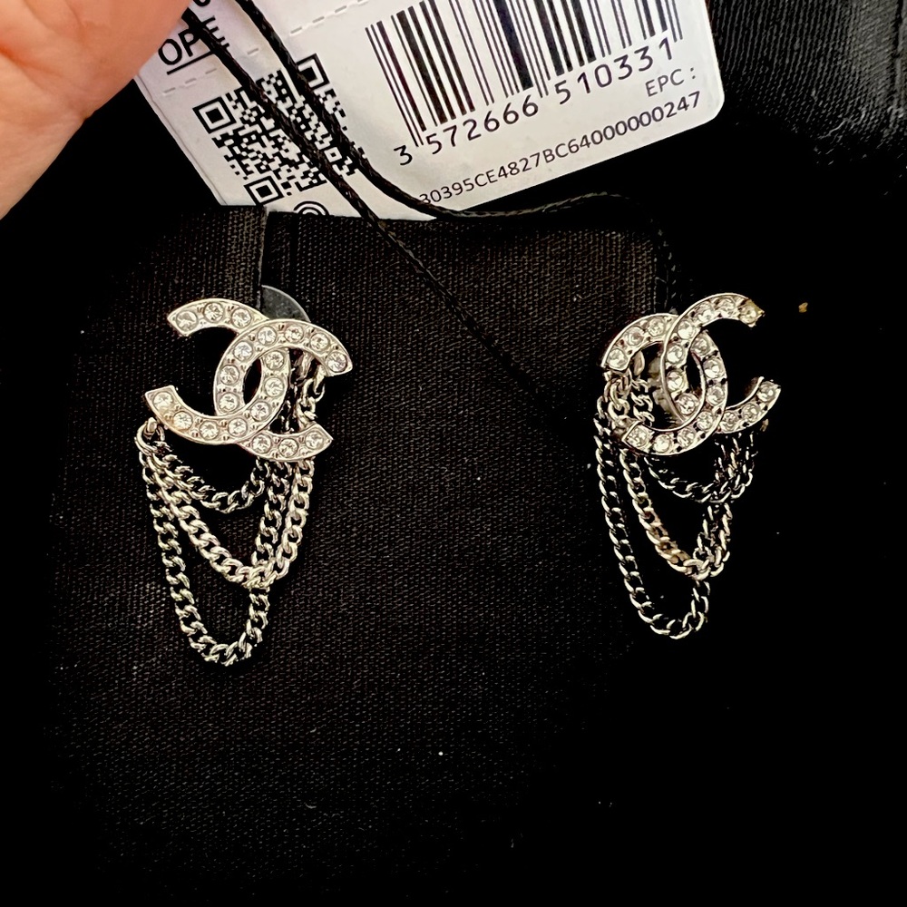 BNWT and box. Chanel stud earrings with chain accent. Silver/ruthenium